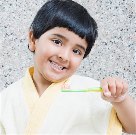 Portrait of a girl holding a toothbrush Stock Photo - Premium Royalty-Free, Code: 630-01492185