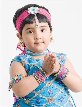 photos of little girl praying - Portrait of a girl wearing traditional clothes and folding her hands Stock Photo - Premium Royalty-Free, Code: 630-01492195