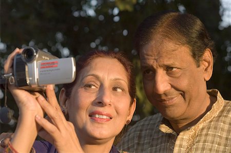 simsearch:614-06895809,k - Close-up of a mature woman holding a digital video camera with a mature man smiling beside her Stock Photo - Premium Royalty-Free, Code: 630-01492237