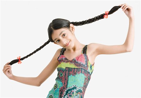 simsearch:630-01709124,k - Portrait of a girl holding her braids Foto de stock - Sin royalties Premium, Código: 630-01492265