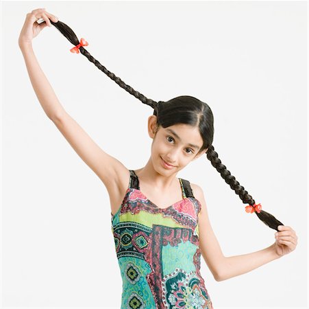 simsearch:630-01709124,k - Portrait of a girl holding her braids Foto de stock - Sin royalties Premium, Código: 630-01492266