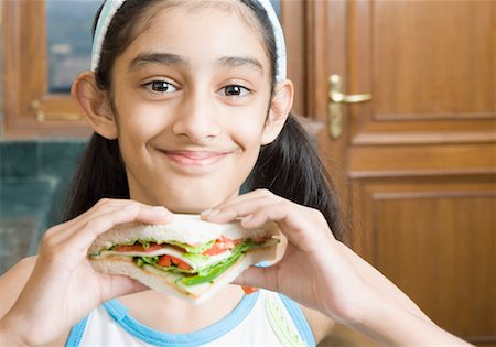 simsearch:630-01873358,k - Portrait of a girl eating a sandwich Stock Photo - Premium Royalty-Free, Code: 630-01492260