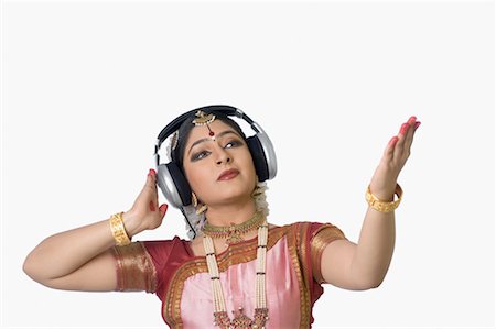 simsearch:630-01491629,k - Young woman wearing headphones and performing Bharatnatyam Stock Photo - Premium Royalty-Free, Code: 630-01492370