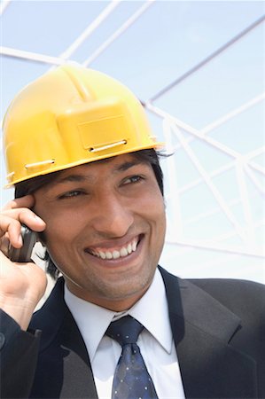 Close-up of an architect talking on a mobile phone Stock Photo - Premium Royalty-Free, Code: 630-01492511