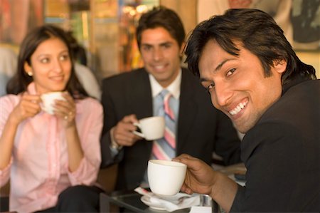 Two businessmen and a businesswoman holding coffee cups Stock Photo - Premium Royalty-Free, Code: 630-01492572