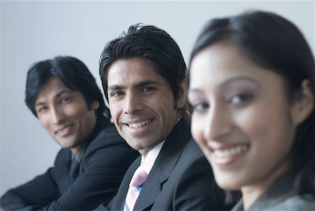 simsearch:630-01128454,k - Portrait of a businesswoman and two businessmen smiling Stock Photo - Premium Royalty-Free, Code: 630-01492606