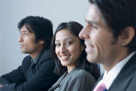 Portrait of a businesswoman and two businessmen smiling Stock Photo - Premium Royalty-Free, Code: 630-01492607