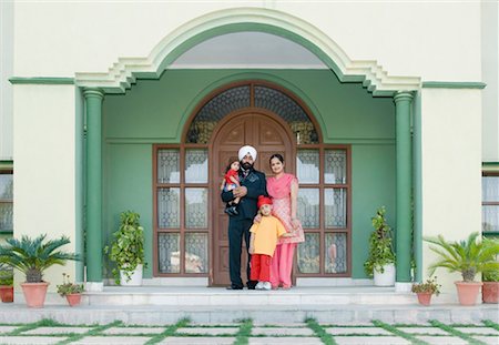 sikhism traditional clothing - Parents standing with their son and daughter at a doorway Stock Photo - Premium Royalty-Free, Code: 630-01492643