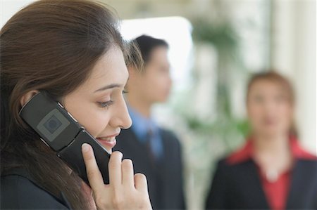 Close-up of a young woman talking on a mobile phone Stock Photo - Premium Royalty-Free, Code: 630-01492681