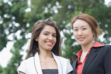 diversity indian workers - Portrait of two businesswomen smiling Stock Photo - Premium Royalty-Free, Code: 630-01492720