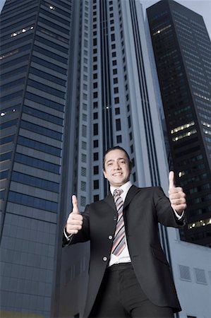 simsearch:630-01492837,k - Portrait of a businessman showing thumbs up sign and smiling Stock Photo - Premium Royalty-Free, Code: 630-01492794