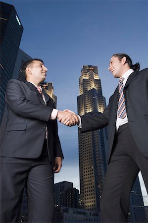 simsearch:630-01492837,k - Two businessmen shaking hands and smiling Stock Photo - Premium Royalty-Free, Code: 630-01492795