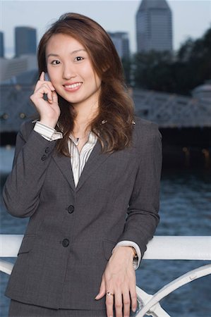 simsearch:630-01492763,k - Portrait of a businesswoman talking on a mobile and smiling Foto de stock - Royalty Free Premium, Número: 630-01492790