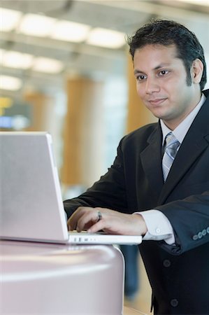 Close-up of a businessman using a laptop Stock Photo - Premium Royalty-Free, Code: 630-01492857