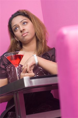 simsearch:630-01130529,k - Young woman sitting in a restaurant and thinking Stock Photo - Premium Royalty-Free, Code: 630-01492896