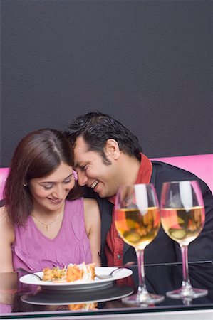 fine food - Young couple sitting in a restaurant and smiling Stock Photo - Premium Royalty-Free, Code: 630-01492921