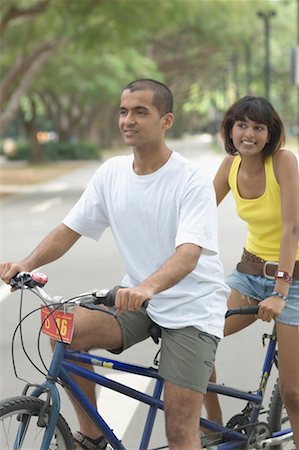Couple sitting on a tandem bicycle Stock Photo - Premium Royalty-Free, Code: 630-01493003