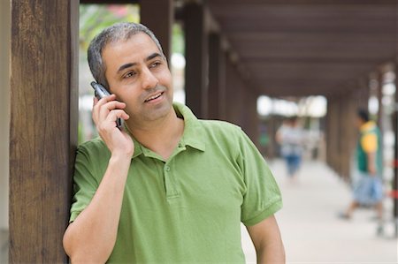 fiore - Close-up of a mid adult man talking on a mobile phone Stock Photo - Premium Royalty-Free, Code: 630-01493036