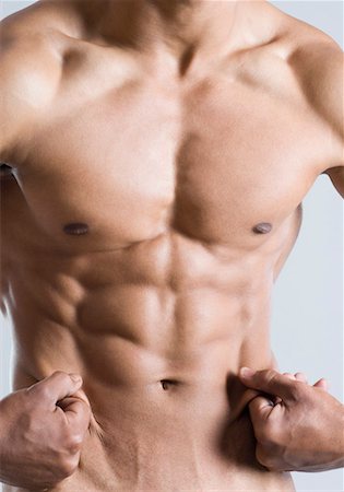 Mid section view of a young man showing his abdominal muscles Stock Photo - Premium Royalty-Free, Code: 630-01493067