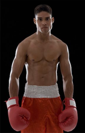 Portrait of a boxer wearing boxing gloves Stock Photo - Premium Royalty-Free, Code: 630-01493089