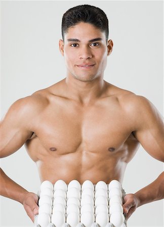 Portrait of a young man holding a carton of eggs Stock Photo - Premium Royalty-Free, Code: 630-01493082