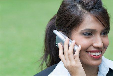 simsearch:630-01128810,k - Close-up of a businesswoman talking on a mobile phone and smiling Stock Photo - Premium Royalty-Free, Code: 630-01707834