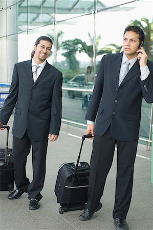 simsearch:630-01873262,k - Two businessmen standing at an airport and waiting Stock Photo - Premium Royalty-Free, Code: 630-01707919