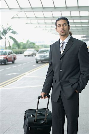 Businessman standing at an airport and waiting Stock Photo - Premium Royalty-Free, Code: 630-01707920