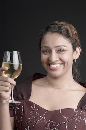 simsearch:630-01708000,k - Portrait d'une jeune femme tenant un verre de vin et souriant Photographie de stock - Premium Libres de Droits, Code: 630-01707959