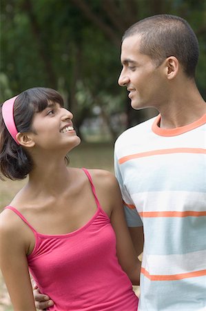 shaving man woman - Young couple standing in a park and looking at each other Stock Photo - Premium Royalty-Free, Code: 630-01708086