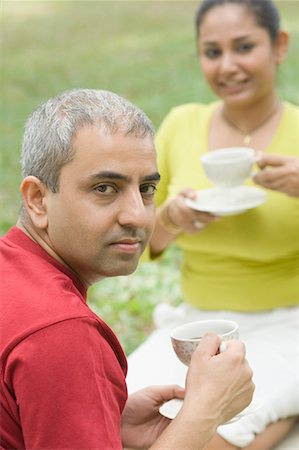 Portrait of a mid adult couple sitting together and drinking tea Stock Photo - Premium Royalty-Free, Code: 630-01708097
