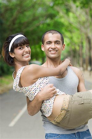 short - Portrait of a young man carrying a young woman in his arms Stock Photo - Premium Royalty-Free, Code: 630-01708120