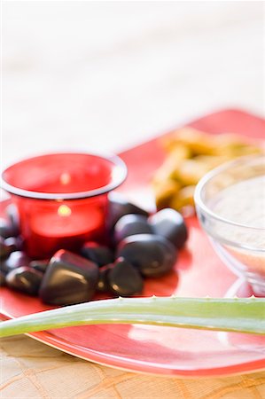 spa stone therapy - Close-up of an aromatherapy candle burning with black pebbles Stock Photo - Premium Royalty-Free, Code: 630-01708254