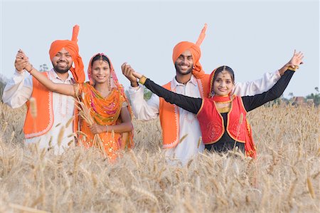 sikhism traditional clothing - Portrait of two young couples dancing in a wheat field Stock Photo - Premium Royalty-Free, Code: 630-01708308