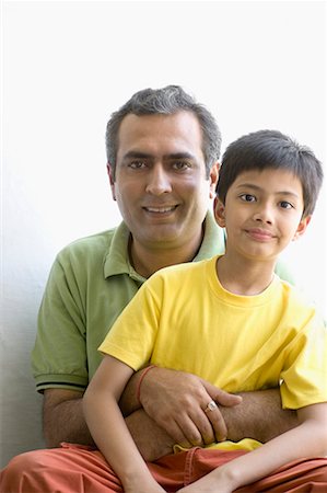 father son two indian - Portrait of a boy sitting with his father Stock Photo - Premium Royalty-Free, Code: 630-01708395