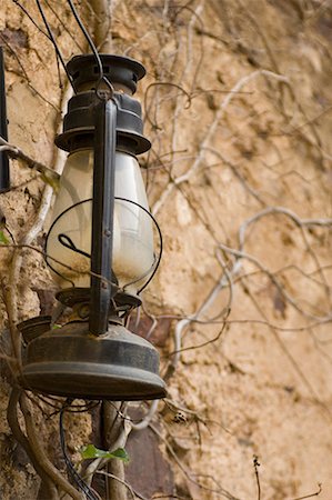 Close-up of a lantern hanging on a wall Stock Photo - Premium Royalty-Free, Code: 630-01708406