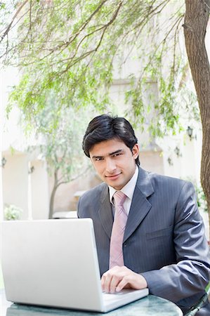 simsearch:630-01708665,k - Portrait of a businessman using a laptop Stock Photo - Premium Royalty-Free, Code: 630-01708497