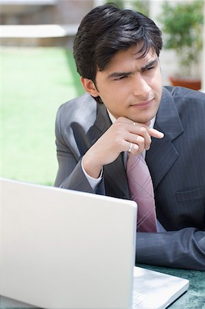 simsearch:630-02219583,k - Close-up of a businessman in front of a laptop Stock Photo - Premium Royalty-Free, Code: 630-01708500