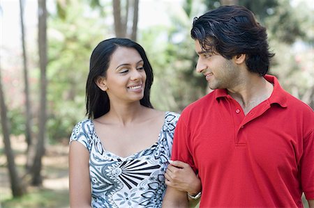 polo shirt woman - Close-up of a young couple with arm in arm and smiling Stock Photo - Premium Royalty-Free, Code: 630-01708580