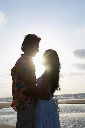 Side profile of a young couple embracing each other Stock Photo - Premium Royalty-Free, Code: 630-01708618