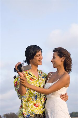 Young couple embracing each other and smiling Stock Photo - Premium Royalty-Free, Code: 630-01708632