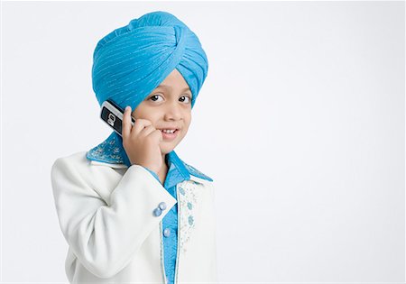 sikhism traditional clothing - Portrait of a boy talking on a mobile phone Stock Photo - Premium Royalty-Free, Code: 630-01708776