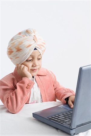 sikh boy alone images - Boy working on a laptop Stock Photo - Premium Royalty-Free, Code: 630-01708786