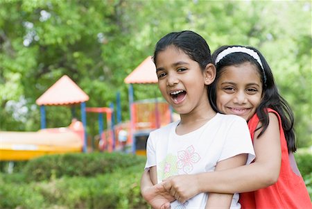 simsearch:630-01873684,k - Portrait of a girl hugging another girl and smiling Fotografie stock - Premium Royalty-Free, Codice: 630-01709085