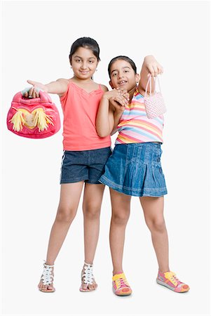 friends black background - Portrait of girls showing their purse Stock Photo - Premium Royalty-Free, Code: 630-01709121