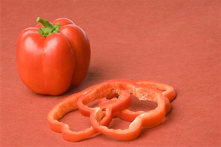 stem vegetable - Close-up of a red bell pepper with slices Stock Photo - Premium Royalty-Free, Code: 630-01709214