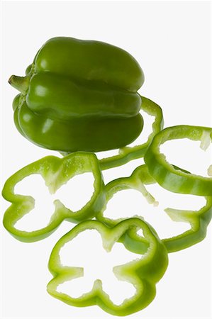 Close-up of a green bell pepper with slices Stock Photo - Premium Royalty-Free, Code: 630-01709231
