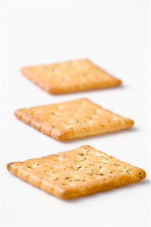 snack cracker white background - Close-up of three biscuits in a row Stock Photo - Premium Royalty-Free, Code: 630-01709418