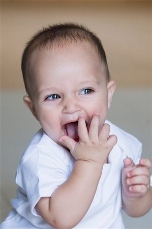 simsearch:630-01709612,k - Close-up of a baby boy laughing and looking away Stock Photo - Premium Royalty-Free, Code: 630-01709563
