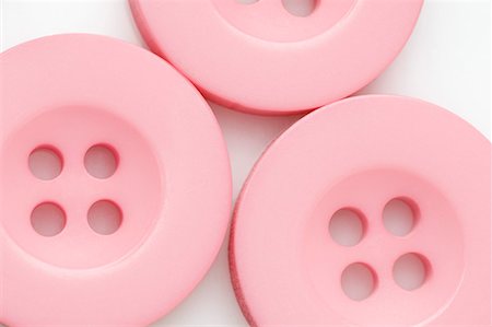Close-up of three pink buttons Stock Photo - Premium Royalty-Free, Code: 630-01709663